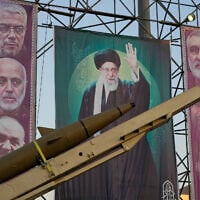 A domestically-built missile "Khaibar-buster," and banners showing portraits of the Iranian Supreme Leader Ayatollah Ali Khamenei, center, and the late armed forces commanders, who were killed in Israeli strike in June, are displayed in a military exhibition commemorating the anniversary of the start of the 1980-88 Iraq-Iran war, and 12-day war with Israel in June, at Baharestan Square, in Tehran, Thursday, Sept. 25, 2025. (AP Photo/Vahid Salemi)