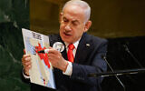 Prime Minister Benjamin Netanyahu holds up a map while speaking at the 80th session of the United Nations General Assembly, Friday, Sept. 26, 2025, at U.N. headquarters. (AP Photo/Stefan Jeremiah)