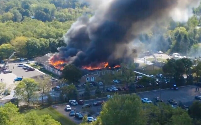 In this image taken from video released by Julie J, @Malkowski6April, Massive flames and smoke rise from The Church of Jesus Christ of Latter-day Saints in Grand Blanc, about 50 miles north of Detroit, September 28, 2025. (Julie J, @Malkowski6April via AP)