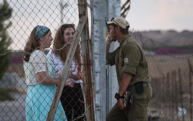Illustrative: An IDF reservist seen parting from his family near the border with Gaza, in southern Israel on July 19, 2014. (Nati Shohat/Flash90)