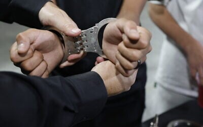 Illustration image of handcuffs on the hands of an arrested man, in Jerusalem, May 21, 2025. (Yossi Zamir/Flash90)