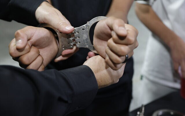 Illustration image of handcuffs on the hands of an arrested man, in Jerusalem, May 21, 2025. (Yossi Zamir/Flash90) Illustration image of handcuffs on the hands of an arrested man, in Jerusalem, May 21, 2025. (Yossi Zamir/Flash90)