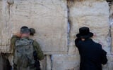 A serviceman belonging to the ultra-Orthodox Hasmonean Brigade prayers at the Western Wall in Jerusalem's Old City, August 6, 2025. (Chaim Goldberg/Flash90)