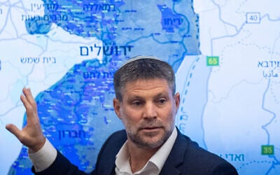 Finance Minister Bezalel Smotrich gestures toward a map of the West Bank during a press conference at the Finance Ministry in Jerusalem, September 3, 2025. (Yonatan Sindel/Flash90)