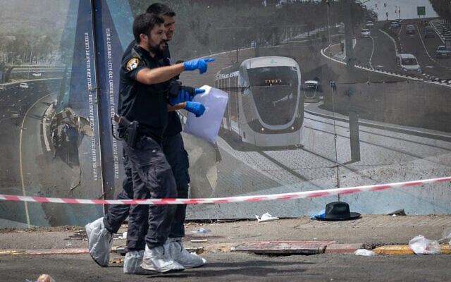 Police and rescue personnel at the scene of a terror attack at Ramot Junction, Jerusalem, September 8, 2025. (Chaim Goldberg/Flash90) Police and rescue personnel at the scene of a terror attack at Ramot Junction, Jerusalem, September 8, 2025. (Chaim Goldberg/Flash90)