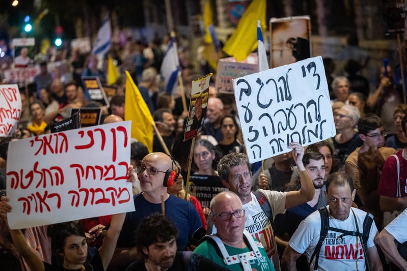 NextImg:Hundreds protest Likud event, minister files complaint, photographer shoved to ground