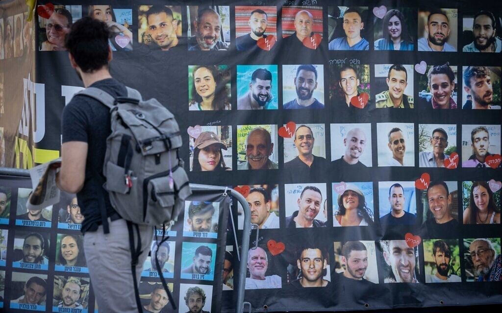 A man looks at a poster depicting hostages, both free and still held, at Hostage Square, in Tel Aviv. September 14, 2025 (Miriam Alster/FLASH90) A man looks at a poster depicting hostages, both free and still held, at Hostage Square, in Tel Aviv. September 14, 2025 (Miriam Alster/FLASH90)