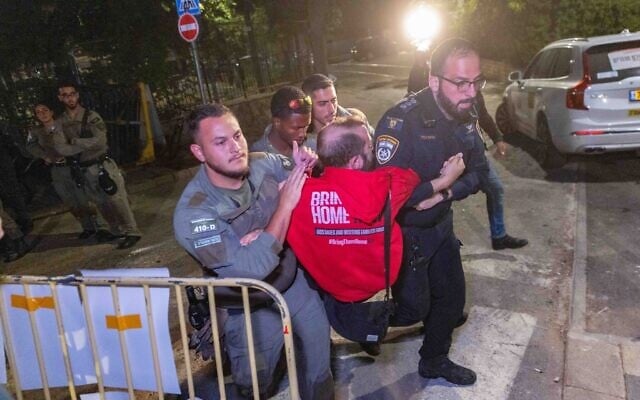 Police remove relatives of hostages and their supporters demonstrating outside Prime Minister Benjamin Netanyahu's residence in Jerusalem, September 16, 2025. (Chaim Goldberg/Flash90)