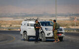 Israeli security forces stand near the scene where two IDF soldiers were killed in a shooting and stabbing attack at the Allenby Bridge Crossing between Israel and the West Bank, September 18, 2025. (Oren Ben Hakoon/Flash90)