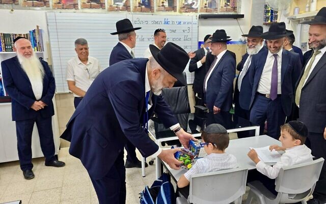 Shas chairman Aryeh Deri attends the first day of classes at a school in Ofakim on September 1, 2025. (Courtesy, Shas)