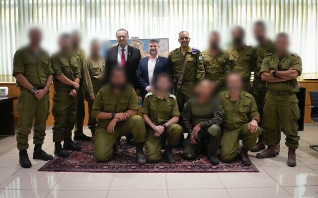 Defense Minister Israel Katz, Finance Minister Bezalel Smotrich, and Maj. Gen. Dado Bar Kalifa with a group of reservists, following the announcement of 'Fighter,' a special benefits club for combat reservists and their spouse, September 4, 2025. (Defense Minister's Office)