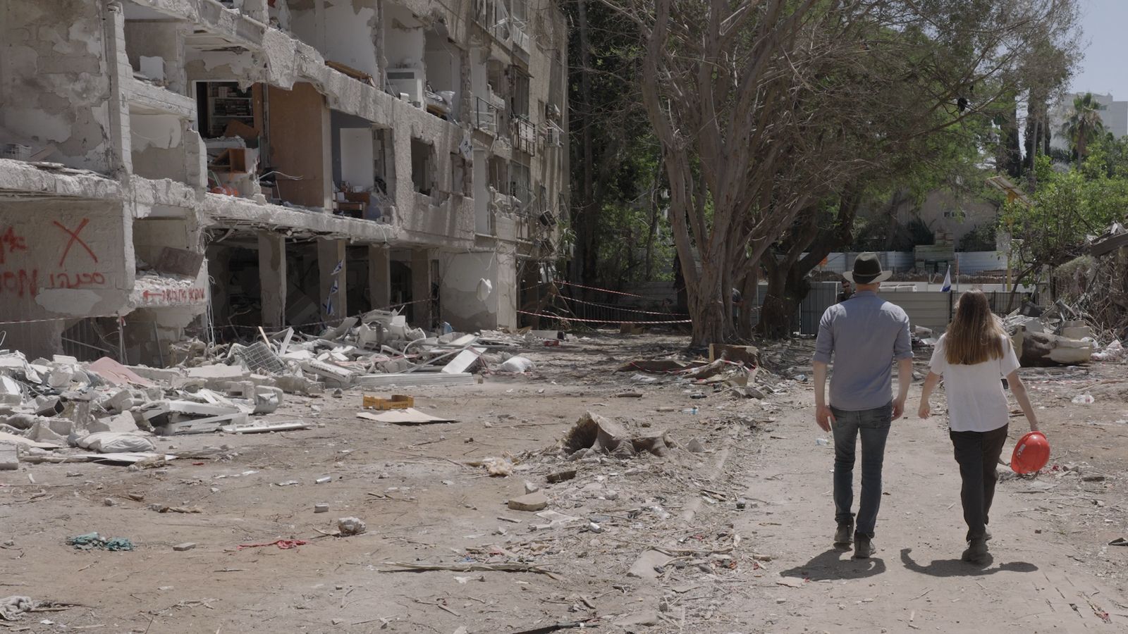 Filmmaker Eli Katzoff walks with Shir from the Lev Ehad organization at a site where an Iranian ballistic missile fell in June 2025. (courtesy) Filmmaker Eli Katzoff walks with Shir from the Lev Ehad organization at a site where an Iranian ballistic missile fell in June 2025. (courtesy)