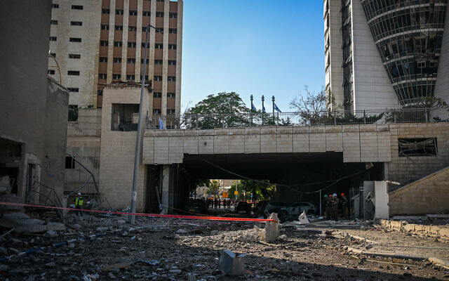 Israeli security and rescue forces at the scene of an Iranian ballistic missile impact in Haifa, June 20, 2025. The Sail Tower is seen on the right. (Flash90) Israeli security and rescue forces at the scene of an Iranian ballistic missile impact in Haifa, June 20, 2025. The Sail Tower is seen on the right. (Flash90)