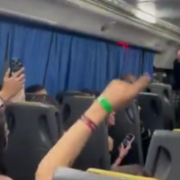 Tour director smiles as he conducts Argentine students chanting 'Today we burn Jews' on graduation trip in screenshot from video that went viral on September 28, 2025. (X, used in accordance with Clause 27a of the Copyright Law)