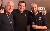Right to left: Tomer Goren and Tal Chotiner, of M&H and Haim Jelin, from Kibbutz Be'eri, at Whisky Live 2024 (Ziv Barak)