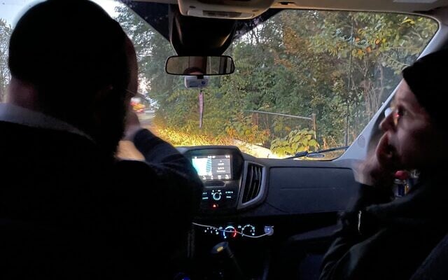 Rabbi Moshe Tauber and wife Chaya Tauber drive up the West Side Highway while checking the Manhattan eruv, a boundary that permits observant Jews to carry items on Shabbat and Jewish festivals. (Jackie Hajdenberg/ JTA)