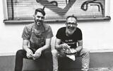 Jalil Dabit, right, wears a shirt that translates to 'I am a hummussexual.' He and Oz Ben David opened Kanaan in 2015. (Elisabeth Patrikiou via JTA)