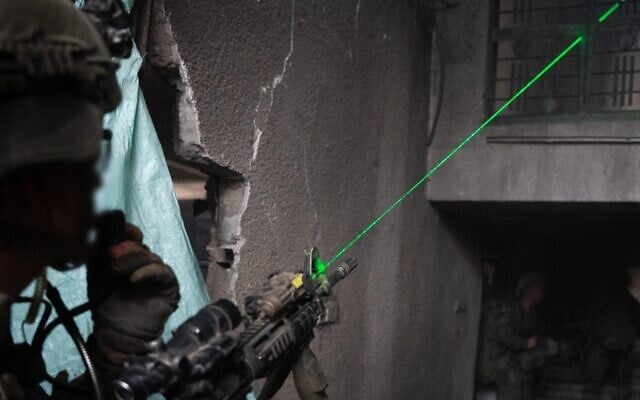 An IDF soldier points a weapon in Gaza in an undated handout photo issued on October 24, 2025. (Israel Defense Forces)