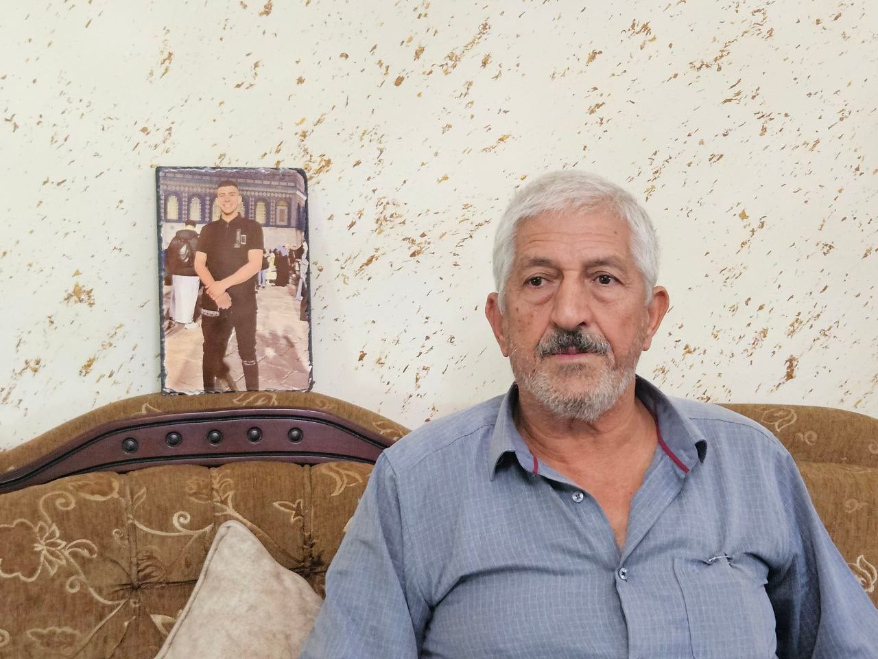 Mohammed Razeem, father of Suhaib Razeem, who was murdered on October 7, 2023, next to a photo of his son at his home in Beit Hanina, East Jerusalem, October 1, 2025. (Nurit Yohanan/ The Times of Israel) Mohammed Razeem, father of Suhaib Razeem, who was murdered on October 7, 2023, next to a photo of his son at his home in Beit Hanina, East Jerusalem, October 1, 2025. (Nurit Yohanan/ The Times of Israel)