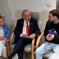 Prime Minister Benjamin Netanyahu and his wife Sara visiting released hostage Alon Ohel at Beilinson Hospital, in Petah Tikva, October 14, 2025. (Avi Ohayon/GPO)