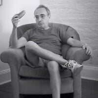 Author Gary Shteyngart holds a cucumber in the short documentary "The Man Who Got Cut Wrong." (Screenshot via 'The New Yorker' on YouTube)
