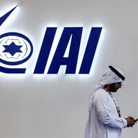A man walks near the Israel Aerospace Industries (IAI) pavilion during the 2023 Dubai Air Show at Dubai World Central-Al-Maktoum International Airport in Dubai, United Arab Emirates, on November 14, 2023. (Karim SAHIB / AFP)