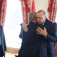 Turkish President Recep Tayyip Erdogan (R) embracing top Hamas official Khaled Mashaal (C) as he meets with then-leader of the terror group Ismail Haniyeh (L) and his delegation at the Dolmabahce Presidential working office in Istanbul, on April 20, 2024. (Handout / TURKISH PRESIDENTIAL PRESS SERVICE / AFP)
