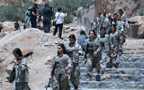 Fighters with the Kurdistan Workers' Party (PKK) descend stairs ahead of a ceremony in Sulaimaniyah, in Iraq's autonomous Kurdistan region, on July 11, 2025. (Shwan MOHAMMED / AFP)