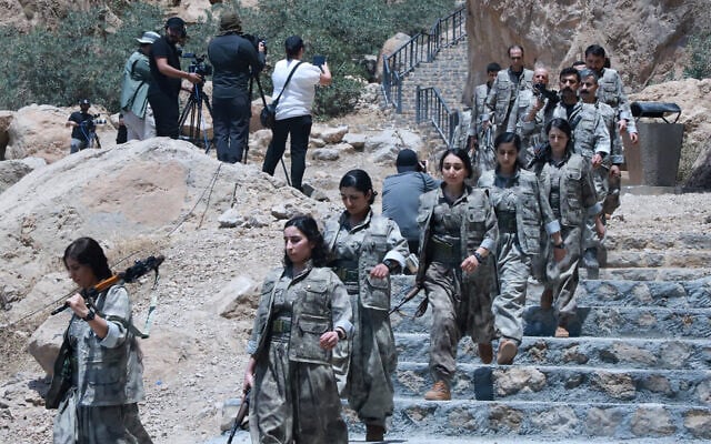 Fighters with the Kurdistan Workers' Party (PKK) descend stairs ahead of a ceremony in Sulaimaniyah, in Iraq's autonomous Kurdistan region, on July 11, 2025. (Shwan MOHAMMED / AFP) Fighters with the Kurdistan Workers' Party (PKK) descend stairs ahead of a ceremony in Sulaimaniyah, in Iraq's autonomous Kurdistan region, on July 11, 2025. (Shwan MOHAMMED / AFP)