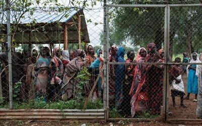Women line up outside a hybrid distribution site to collect food at a refugee camp in Maban, South Sudan on August 20, 2025. (Guy Peterson / AFP)