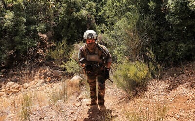 Illustrative: A peacekeeper of the United Nations Interim Force in Lebanon (UNIFIL) walks at a position formerly held Iran-backed Hezbollah in the Khraibeh Valley in el-Meri in south Lebanon on August 27, 2025. (ANWAR AMRO / AFP)