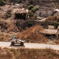An armored vehicle of the United Nations Interim Force in Lebanon (UNIFIL) moves past destroyed buildings along a road in the village of Kfar Kila in southern Lebanon near the border with northern Israel on August 27, 2025. (ANWAR AMRO / AFP)