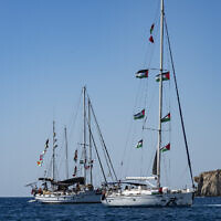 Members of the group of ships of the Global Sumud Flotilla to Gaza are seen moored at the small island of Koufonisi, south of the island of Crete, on September 26, 2025. (Photo by Eleftherios ELIS / AFP)