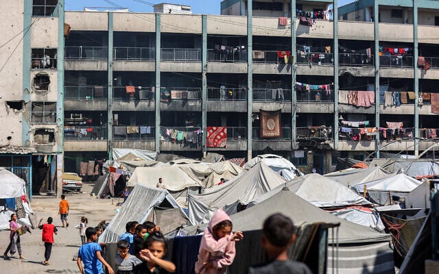 Tents sheltering people displaced by conflict are pitched in the yard of a school run by the United Nations Relief and Works Agency (UNRWA) in Khan Younis in the southern Gaza Strip on September 30, 2025. (Omar AL-QATTAA / AFP)