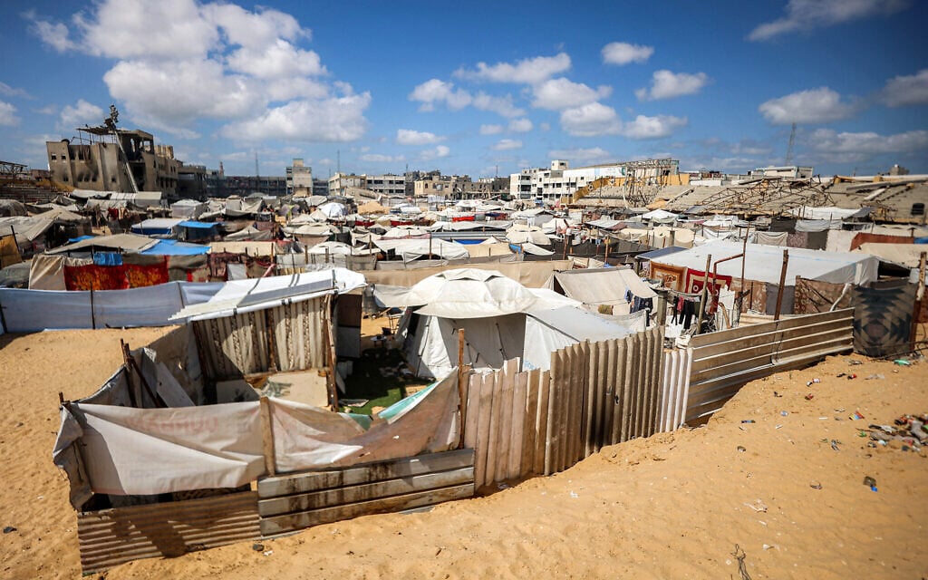 Tents at a makeshift camp for people displaced by conflict are pictured in the football pitch of a school run by the United Nations Relief and Works Agency (UNRWA), in Khan Younis in the southern Gaza Strip on September 30, 2025. (Omar AL-QATTAA / AFP)