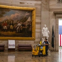 A member of the cleaning staff makes her way through the Rotunda on an empty US Capitol in Washington, DC, on September 30, 2025. (ANDREW CABALLERO-REYNOLDS / AFP)