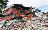 Rescuers search for three people who were reported missing under the rubble of a collapsed building in Bogo City on October 1, 2025, after a powerful 6.9 magnitude earthquake jolted the central Philippines. (TED ALJIBE / AFP)