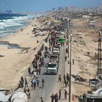 Palestinians carrying belongings arrive on a coastal path northwest of Nuseirat refugee camp as they are displaced southward following Israel's announcement that it would stop northbound traffic on the coastal Rashid road, October 1, 2025. (Bashar TALEB / AFP)