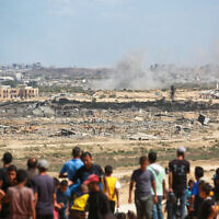 Palestinians watch smoke billowing during airstrikes, northwest of the Nuseirat refugee camp in the central Gaza Strip, October 1, 2025. (Bashar TALEB / AFP)