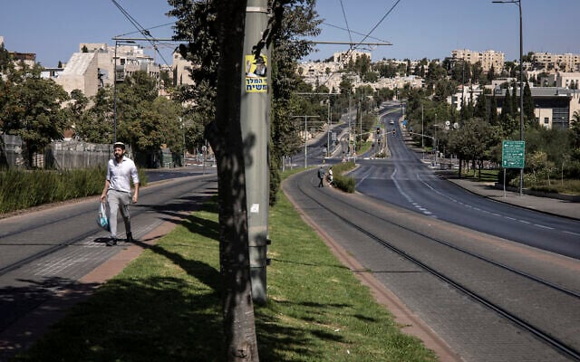 A Jewish man walks up an empty road during Yom Kippur, the day of atonement, in Jerusalem on October 2, 2025. (JOHN WESSELS / AFP)