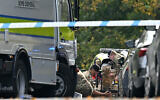 Members of the Armed Forces work by a bomb disposal van as they prepare a Harris T7 Multi-Mission Robot inside a police cordon at Heaton Park Hebrew Congregation synagogue in Crumpsall, north Manchester, on October 2, 2025 (Oli SCARFF / AFP)