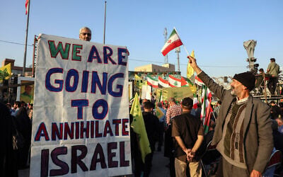 An Iranian man holds an anti-Israeli placard during a ceremony to mark the first anniversary of the death of Hezbollah leader Hassan Nasrallah, in Tehran, on October 2, 2025. (Photo by AFP)