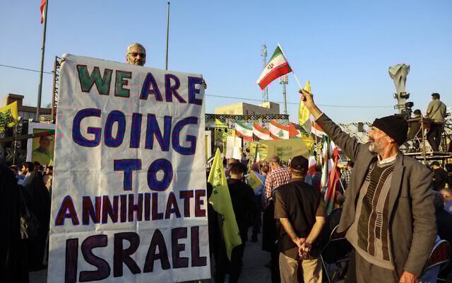 An Iranian man holds an anti-Israeli placard during a ceremony to mark the first anniversary of the death of Hezbollah leader Hassan Nasrallah, in Tehran, on October 2, 2025. (Photo by AFP)