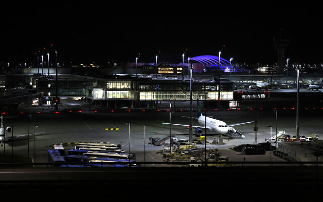 Night view shows an Air Lingus plane grounded at Munich International Airport in Munich, southern Germany, on early October 4, 2025, after reports of drone sightings again forced Munich airport to close  (Photo by Michaela STACHE / AFP)