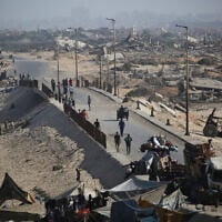 Palestinians walk on a coastal path northwest of the Nuseirat refugee camp as they are displaced southward following an Israeli announcement of closing Al-Rashid road towards the north of the besieged Gaza Strip on October 4, 2025. (Eyad Baba/AFP)