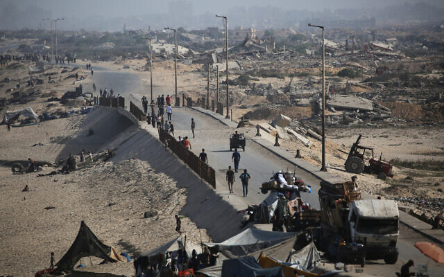 Palestinians walk on a coastal path northwest of the Nuseirat refugee camp as they are displaced southward following an Israeli announcement of closing Al-Rashid road towards the north of the besieged Gaza Strip on October 4, 2025. (Eyad Baba/AFP) Palestinians walk on a coastal path northwest of the Nuseirat refugee camp as they are displaced southward following an Israeli announcement of closing Al-Rashid road towards the north of the besieged Gaza Strip on October 4, 2025. (Eyad Baba/AFP)