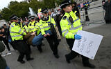 A protester is taken away by police officers at a "Lift The Ban" demonstration in support of the proscribed group Palestine Action, calling for the recently imposed ban to be lifted, in Trafalgar Square, central London, October 4, 2025. (Justin Tallis/AFP)