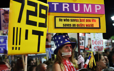 A woman dressed in a costume in the colors of the US flag holds a sign urging US President Donald Trump to seal a Gaza ceasefire-hostage deal, during a rally in support of the hostages at Hostages Square in Tel Aviv, October 4, 2025. (Jack GUEZ / AFP) A woman dressed in a costume in the colors of the US flag holds a sign urging US President Donald Trump to seal a Gaza ceasefire-hostage deal, during a rally in support of the hostages at Hostages Square in Tel Aviv, October 4, 2025. (Jack GUEZ / AFP)