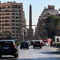 Vehicles move around the obelisk of Ramses II in the center of Cairo's Tahrir Square on October 6, 2025. (Khaled DESOUKI / AFP)