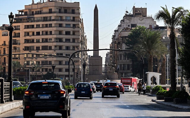 Vehicles move around the obelisk of Ramses II in the center of Cairo's Tahrir Square on October 6, 2025. (Khaled DESOUKI / AFP)